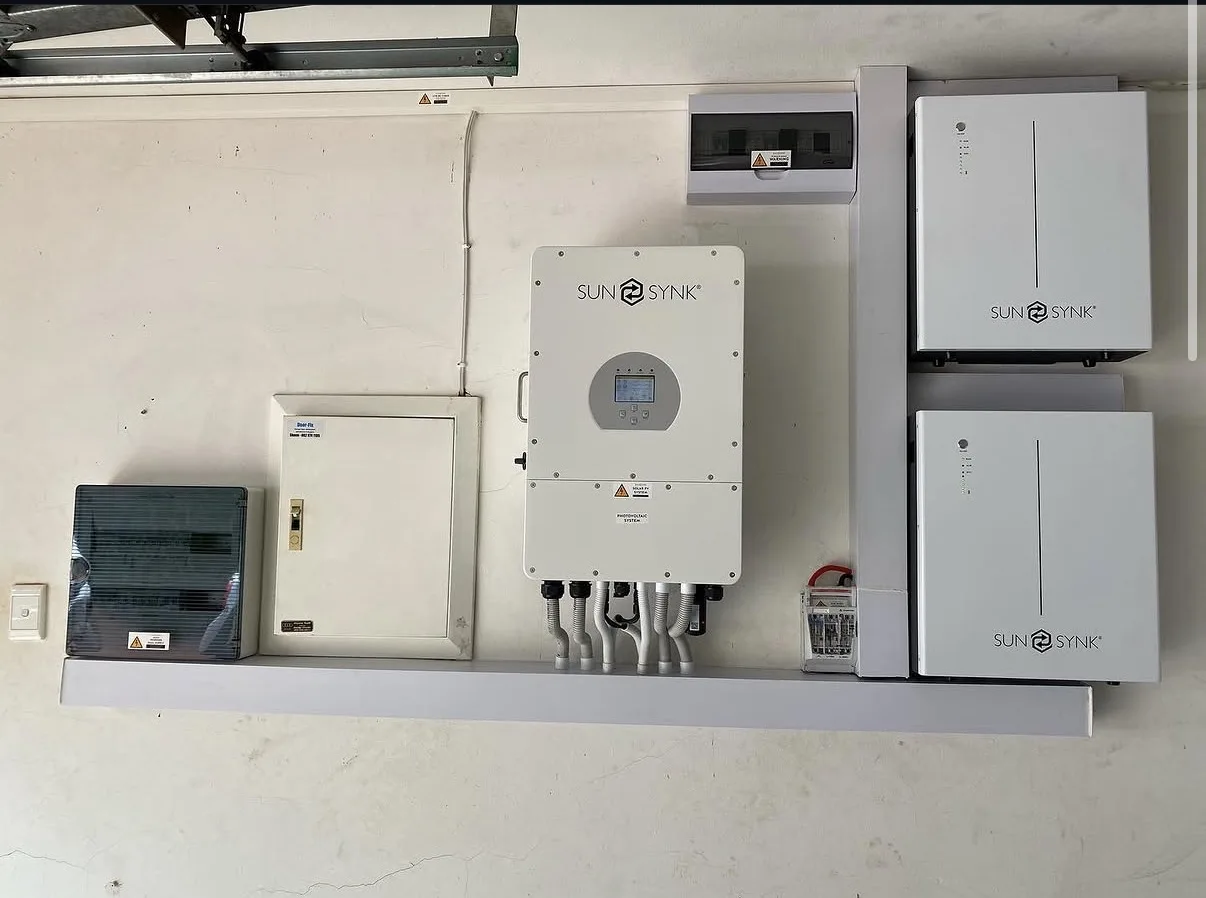 Sunsynk inverter and two batteries installed in a garage